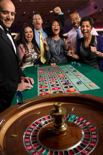 Mobile phone showing live casino table with roulette wheel and dealer